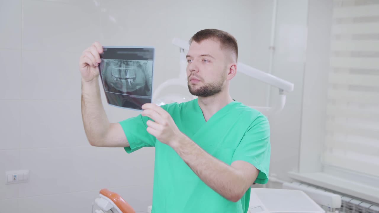 Dentist examining dental x-ray