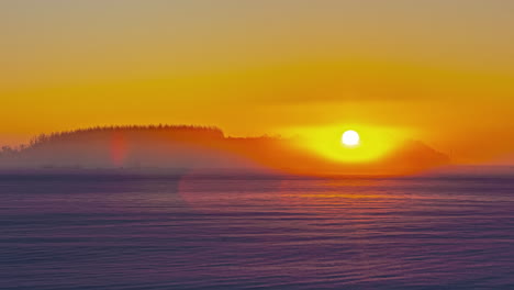 Timelapse-shot-of-golden-sunrise-over-snow-covered-agricultural-fields-along-rural-countryside