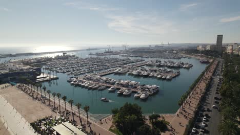 Orbiting-over-Alicante-Recreation-Harbor,-Sailing-boats-moored-at-the-Marina,-Spain