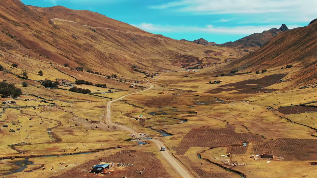 Car driving along a remote road on the Lares trek, Peru. Aerial drone view