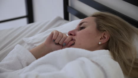 blonde person laying on the bed