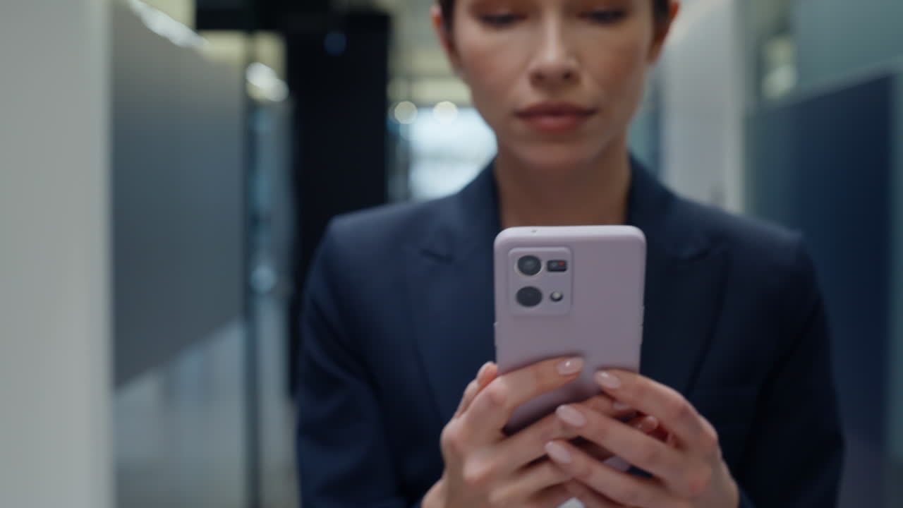 Businesswoman hands holding cellphone in vestibule closeup. Woman messaging