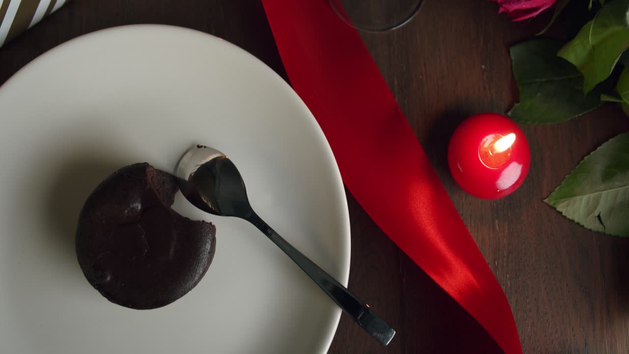 Cosy dinner setting with chocolate pudding and champagne with red candles