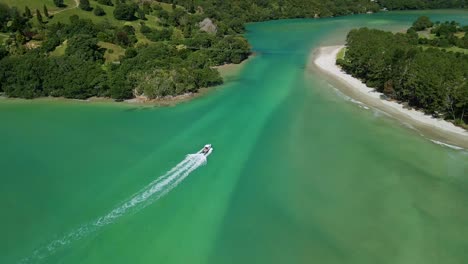 boat driving through sand bar at high tide with swirl pattern in the sand