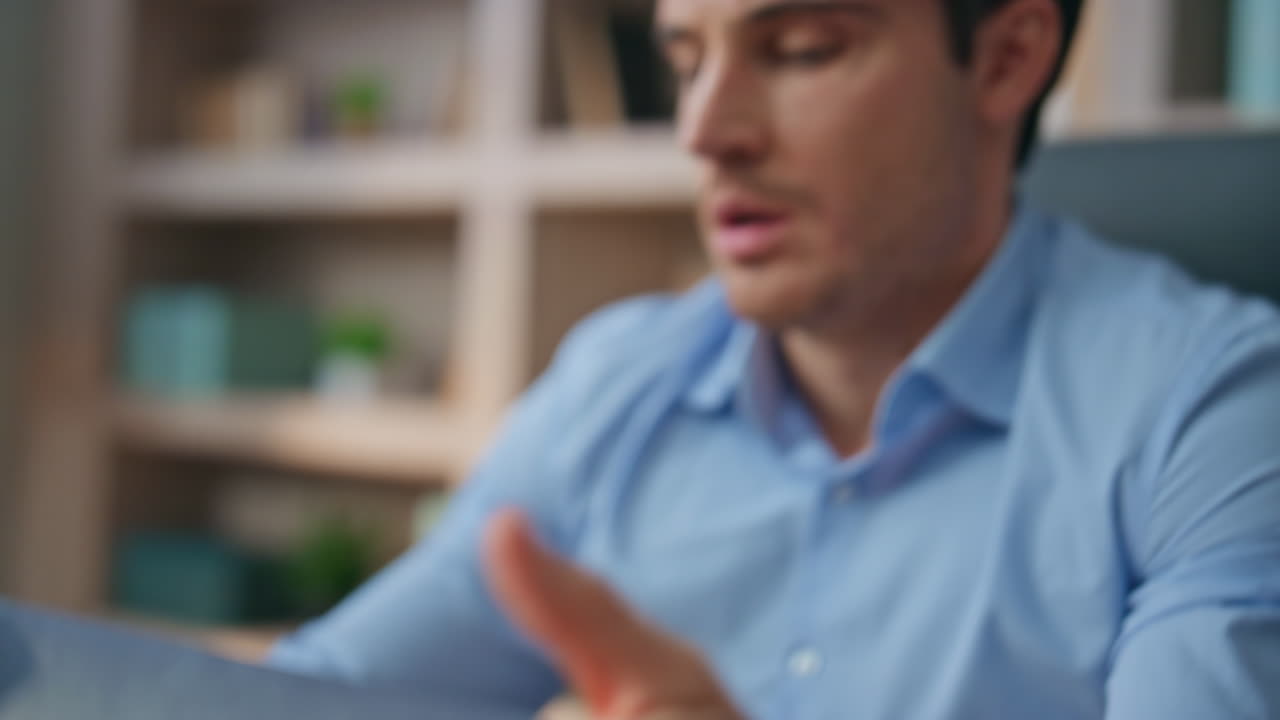 Closeup student typing computer in home office. Stressed busy man rubbing eyes