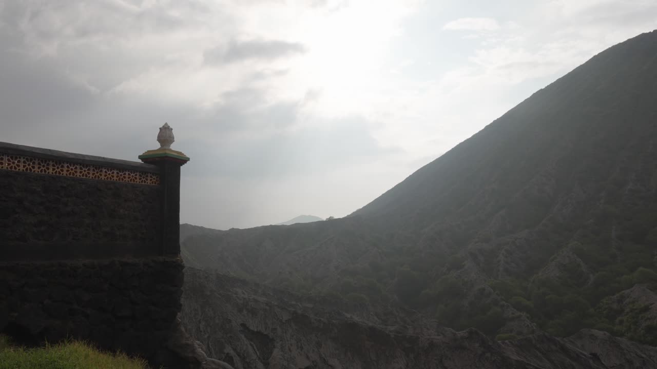 Pura luhur poten hindu temple beside the misty volcanic terrain of Mount Batok, East Java, Indonesia
