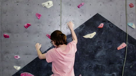 Teenage-boy-climbing-indoors