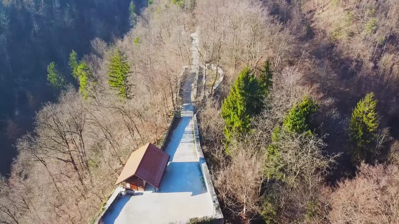 Fly over Castle Zovnek on the hill, Braslovce. Tower and walkway to the cliffs