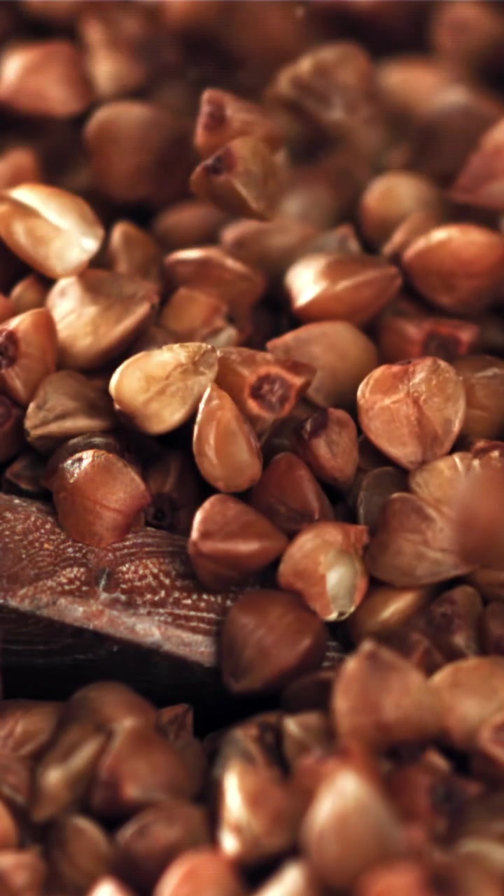 Raw Buckwheat Grains Falling in Macro Slow Motion