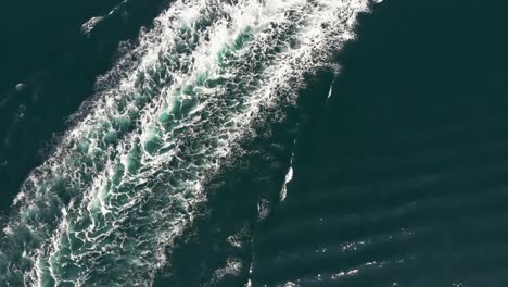 the cool white waves of sea waters in lysekil sweden after a vessel passed by - aerial shot