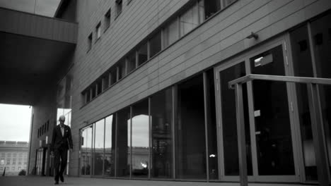 businessman in a suit walking in front of a building