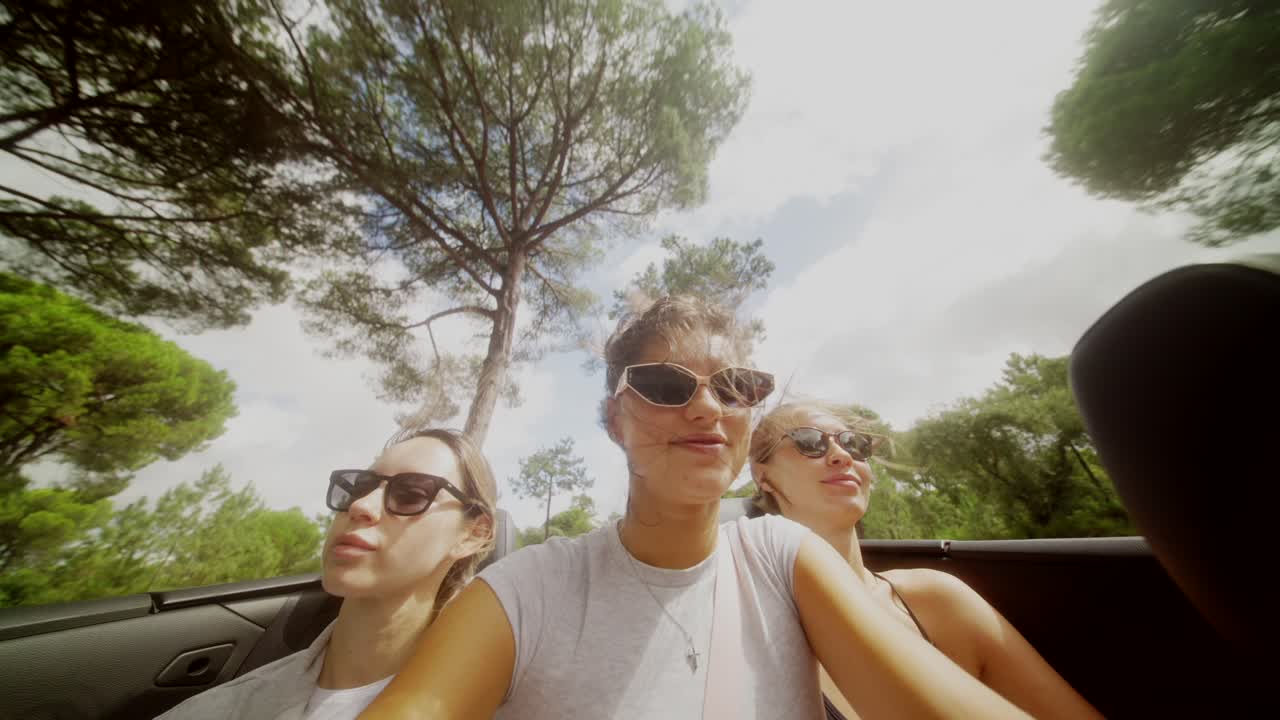 Women enjoying a road trip in a convertible