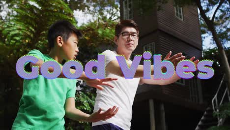 Animation-of-good-vibes-text-over-asian-father-and-son-exercising