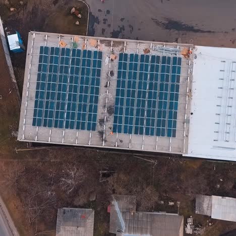 construction of modern solar farm on roof. workers build new solar station. photovoltaic solar panels generate clean energy from the sun. aerial view.