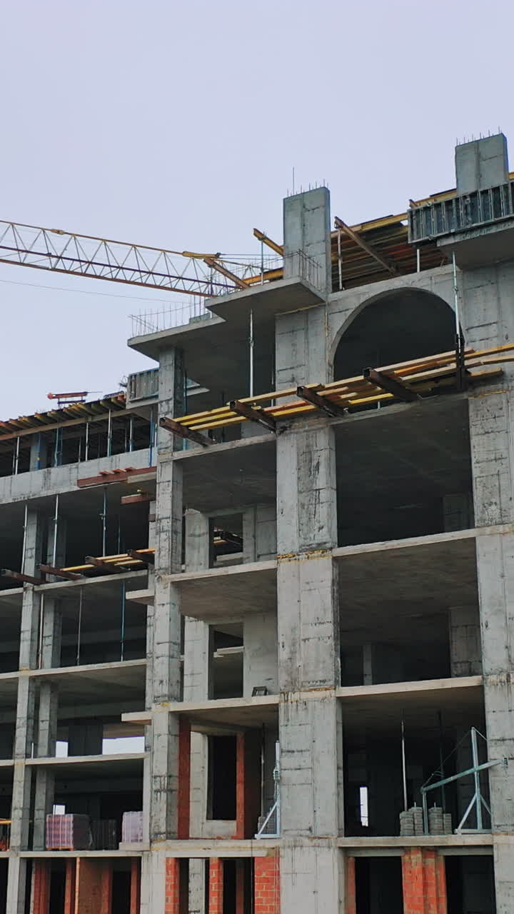 Construction of a residential apartment complex. Aerial view. Vertical video