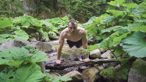 sport in nature, person doing push-ups. slow motion.