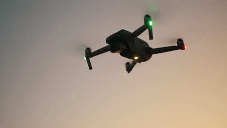 close-up aerial of drone flying in mid-air during golden hour