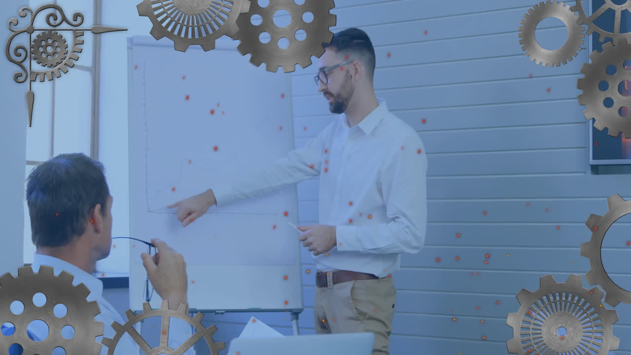 Business presenter pointing line graph in office meeting room, highlighting metallic gear overlays
