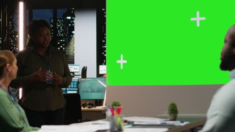 diverse team in a dark office shares insights and exchanges feedback