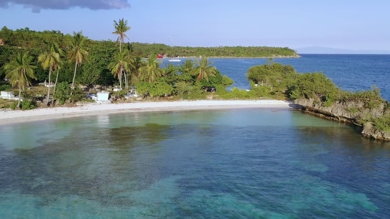 Paradise white sand beach. Calm turquoise water with palm trees. Philippines, Asia