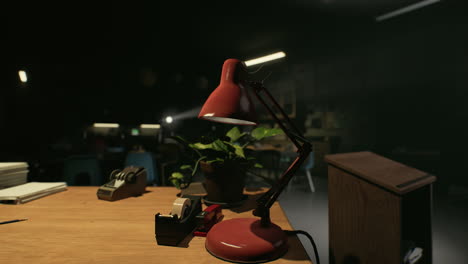 red desk lamp on wooden desk in dark classroom or office