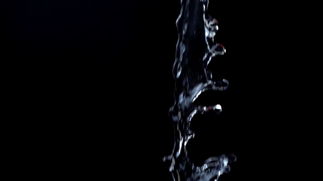 Water on a black background. Slow motion
