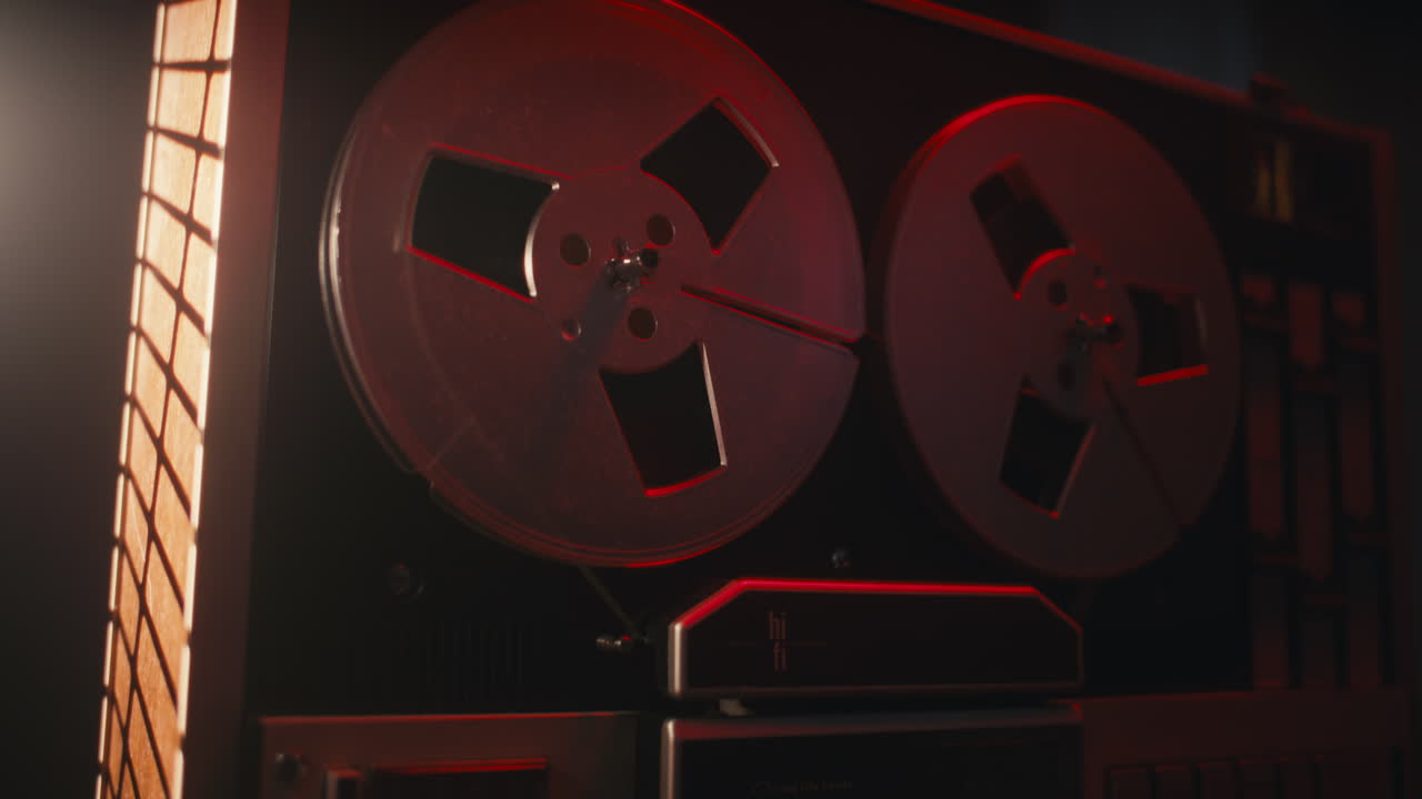 A vintage tape recorder in a red blinking light