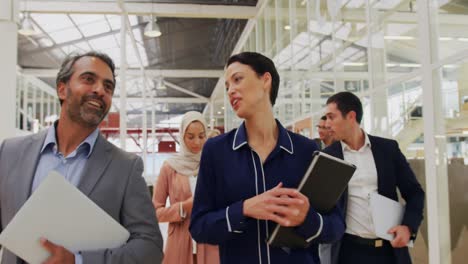 Business-people-talking-and-walking-in-a-conference-foyer