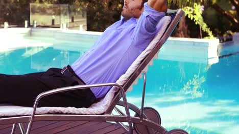 handsome man resting on deck chair