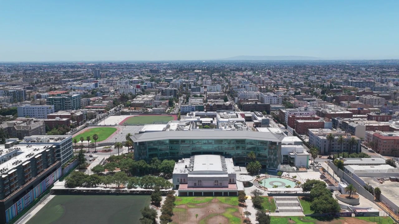 Bredt luftfoto med tilbaketrekking av Robert F. Kennedy Community Schools, tidligere sted for det historiske Ambassador Hotel i Los Angeles, California. 4K