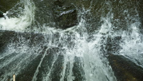 top angle shot ot a small waterfall from a dam