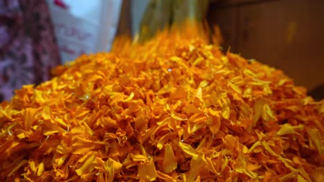 pile of fresh marigolds for sale in street market in agra, india - closeup shot