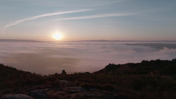 Aeria View Of A Valley Covered By Dense Mist From The Top Of A Mountain
