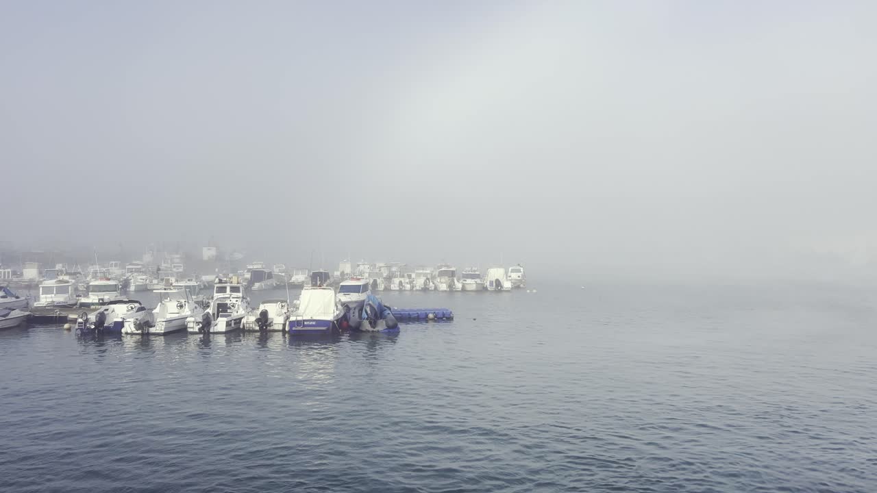 Foggy port with yachts and boats
