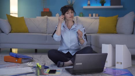 Home-office-worker-woman-looks-at-camera-with-happy-and-smiling-face.