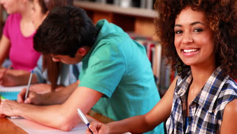 jóvenes estudiantes estudiando juntos en la biblioteca