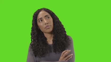 frustrated woman looking at mobile phone against green screen 1