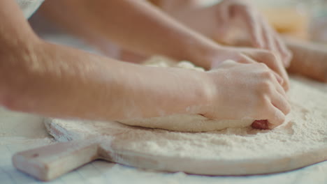 mother and daughter kneading the dough