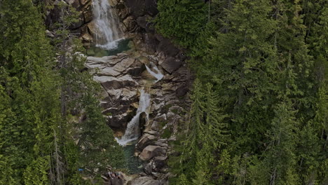 Shannon-Falls-BC-Canada-Aerial-v4-birds-eye-view-drone-flyover-capturing-cliffside-waterfalls-cascading-down-the-rocky-cliff-and-rock-pools-amidst-the-forest---Shot-with-Mavic-3-Pro-Cine---July-2023