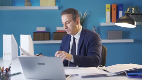 Stressed-out,-depressed-or-overworked-businessman-at-office-desk.