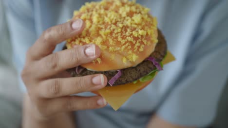 hand holding a hamburger
