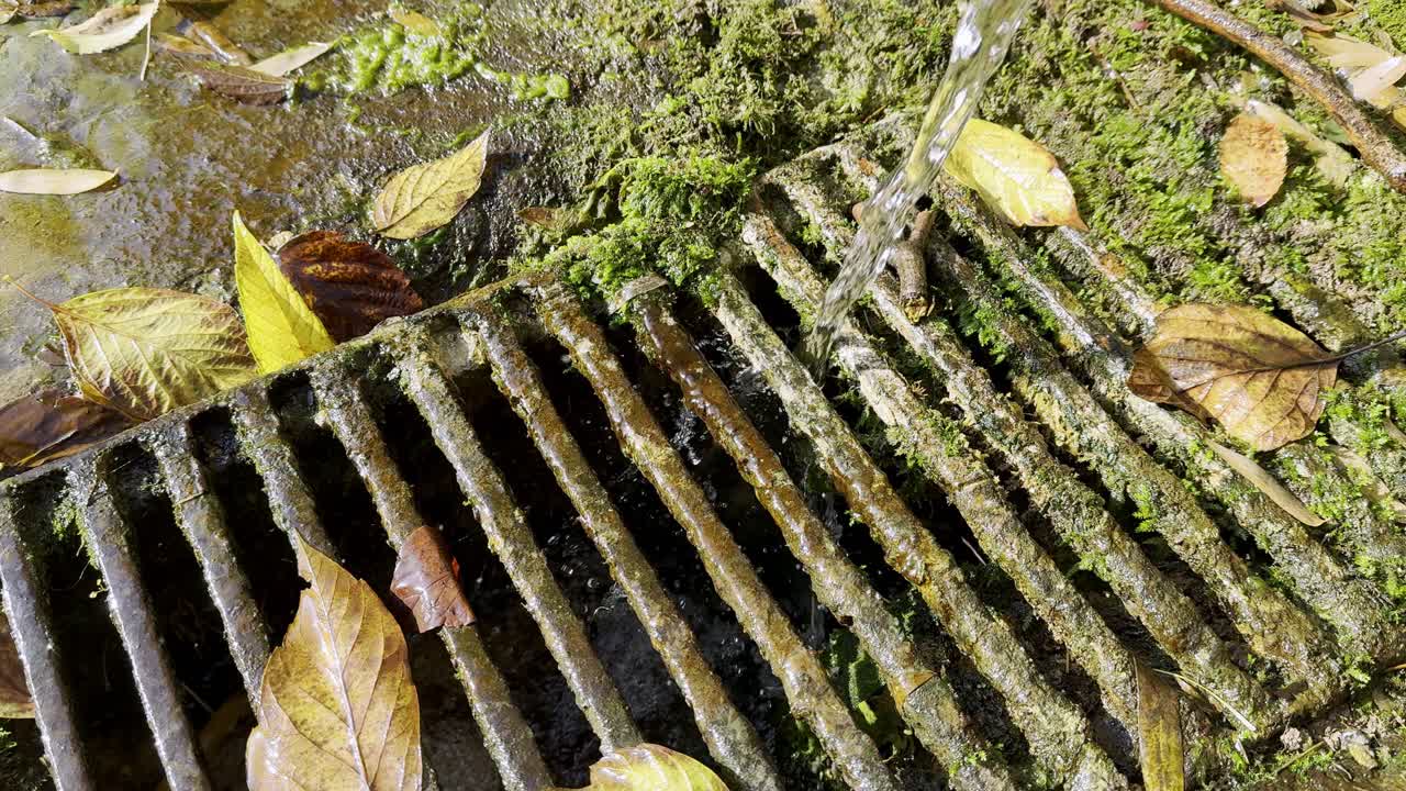 Water drainage grate with stream falling down in slow motion, 4K120 slowed done to 4K30