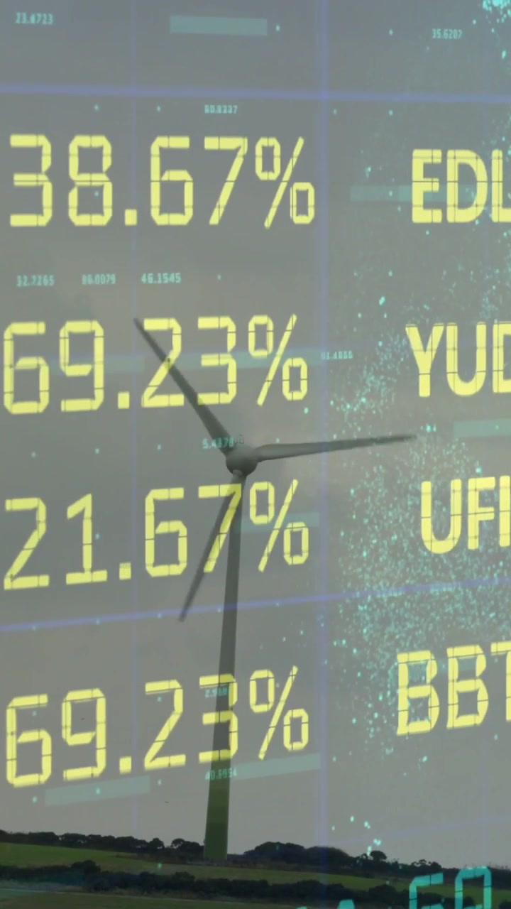 Vertical video: Breeze spinning turbine while finance feed updating yellow tickers and blue noise