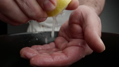 chef drains a lemon to prepare cebiche