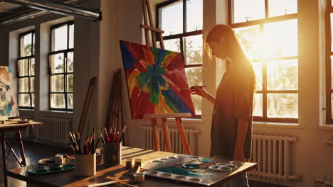 artist painting in a sunlit studio