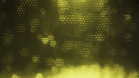yellow abstract optical blurred background. optical bokeh overlapped by moving honeycombs.
