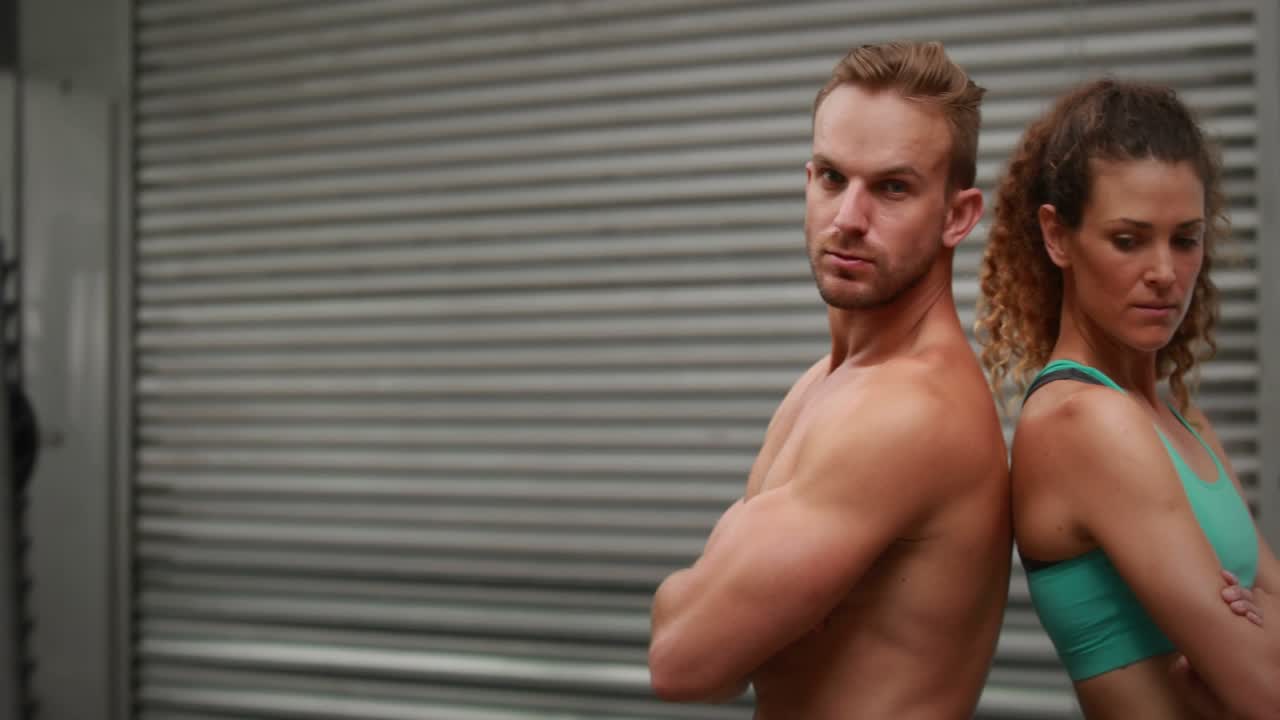 Fitness duo standing back-to-back animated HUD sweeping across frame revealing her face for promo
