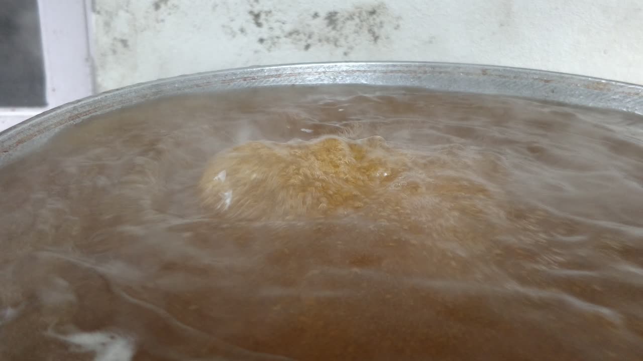 Close up view of a sugar syrup preparation on a large pan