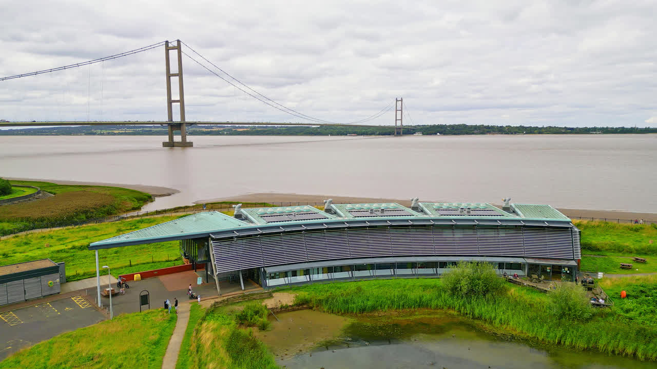 Witness the Waters' Edge Country Park and Visitor Centre, set against the iconic Humber Bridge, from a breathtaking aerial perspective