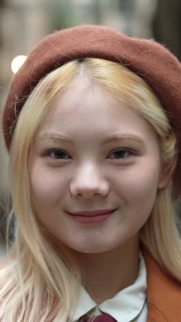 portrait of a woman with blonde hair and a beret